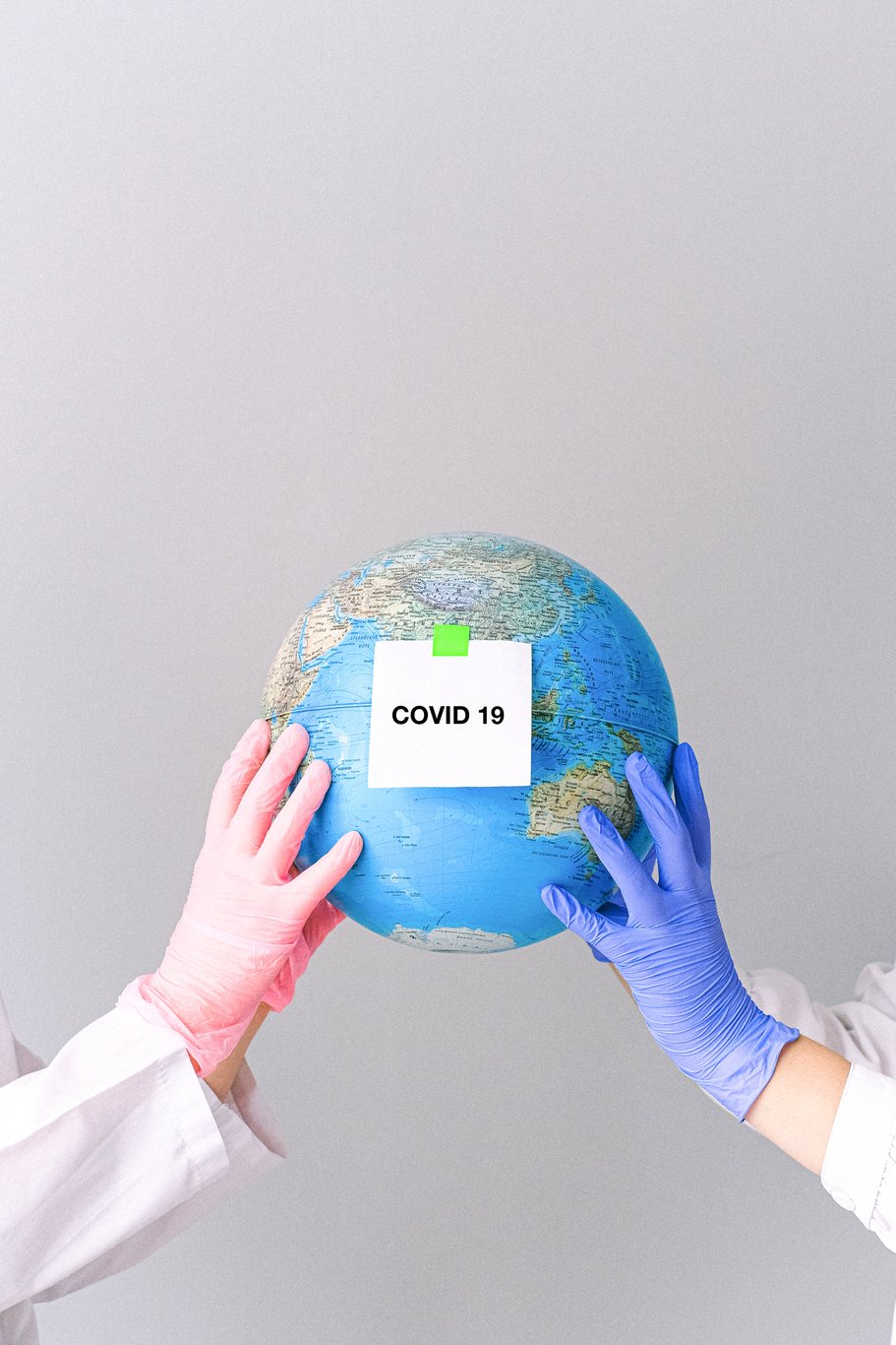hands-with-latex-gloves-holding-a-globe-4167559